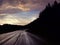 Black Hills motorcyclists ride at sunset on wet road