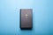 Black holy bible on bright blue background