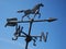 Black horse weather vane blue sky