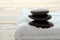 Black Hot Polished Stone Cairn on a Towel in a Spa