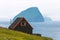 Black house on famous faroese Witches Finger Trail