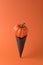 Black ice cream cone with autumn pumpkin. Halloween minimal concept