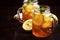 Black ice tea with lemon slice in glass jar on dark kitchen table background, summer cool soft drink, selective focus