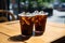 A black iced coffee on the table at a coffee shop