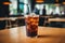 A black iced coffee on the table at a coffee shop