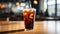 A black iced coffee on the table at a coffee shop