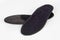 Black Insoles isolated on a white background. Medical orthopedic insoles. Foot care. Insole cutaway layers. Treatment