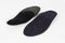 Black Insoles isolated on a white background. Medical orthopedic insoles. Foot care. Insole cutaway layers. Treatment