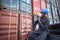 Black Inspector with Inspecting the Containers at the Port