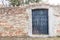 Black iron door in a brick wall, Burano, Italy