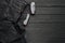 Black jeans on a dark black wooden background.Frayed jeans on a rough wood surface.Copy space for text