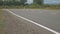 A black jeep goes on the road, shooting a new road surface in the countryside on which the car passes, in the background