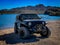Black Jeep Wrangler off-roading on Arizona trails near a lake