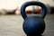 Black Kettlebell on a gym floor