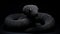 Black Knitted Snake Sculpture On Black Background