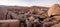 Black labrador retriever climbing among boulders in Yucca Valley California desert