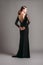 Black lace trumpet dress. Evening floor length gown with deep v neck line and long sleeves