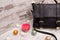 Black ladies handbag on a wooden background, Christmas ornaments, garland and candle.