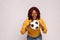 black lady holding a football shows her passion