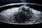 Black lava salt is a salt with a distinctive glossy black color, coarse grain in a wooden bowl