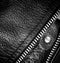 Black leather clothing with a zipper. macro photo