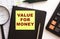 Black leather notebook with colored sticker with the inscription. Financial concept