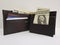 black leather wallet with american dollars banknotes and white background