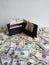 black leather wallet with american dollars bills