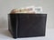 black leather wallet with russian banknotes and white background