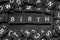 Black letter tiles spelling the word & x22;birth& x22;