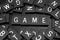 Black letter tiles spelling the word & x22;game& x22;