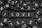 Black letter tiles spelling the word & x22;love& x22;