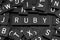 Black letter tiles spelling the word & x22;ruby& x22;