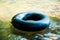 Black life ring floating on water.