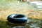 Black life ring floating on water.