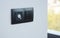 Black light switch on the modern house wall. Socket, air coditioning button,  european power