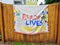 Black Lives Matter Banner Hanging Over Wood Fence In A Neighborhood