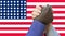 Black lives matter. Close up photo of a handshake between afroamerican and european hands. Handshake in front of us flag