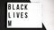 BLACK LIVES MATTER text animation on a black and white background. Protest against the end of racism, anti-racism