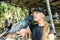 A black Macaw taking a sunflower seed from a girlâ€™s mouth. Australian Black Macaw Parrot.