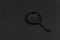 Black magnifying glass on black background. Magnifier. Search