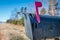 Black mail box and post office mail with blue sky