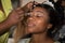 black makeup artist making a make up for african american bride