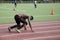 Black male athlete makes practice run on stadium track in Bronx NY