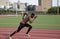 Black male athlete makes practice run on stadium track in Bronx NY