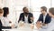 Black male boss leading corporate in team meeting
