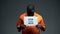 Black male prisoner holding stop physical abuse sign in cell, sexual harassment