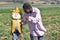 Black man in a California farm playing with a scarecrow