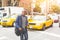 Black man crossing a street in New York.