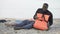 Black man crying hugging life jacket, survived plane crash on deserted island